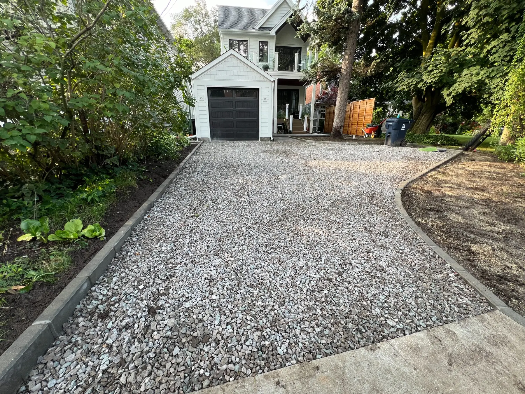 Excavated and compacted driveway base preparation.